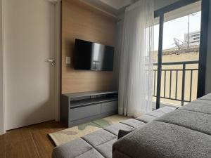 a bedroom with a flat screen tv on a wall at Max Jardim São Paulo in São Paulo
