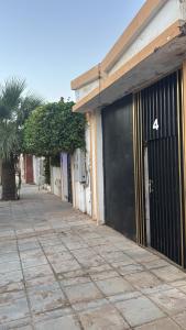 a building with a black door with the number four at رفيف باريس نجد in Unayzah