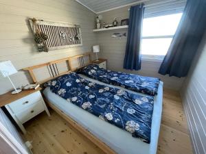 a small bedroom with a bed and a window at Cabin with stunning views and outdoor jacuzzie in Leset