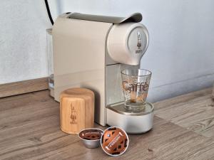 a coffee maker sitting on the floor with a glass at Martina Domus,South Sardinia, 5-star sea in Carbonia