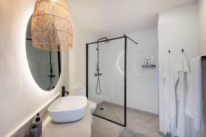 a bathroom with a shower and a toilet and a sink at Seascape Plettenberg Bay in Plettenberg Bay +30 photos