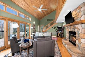 a living room with a stone fireplace and a couch at You Betcha - Charming 3BR Arcade & Near Lutsen & Grand Marais in Grand Marais