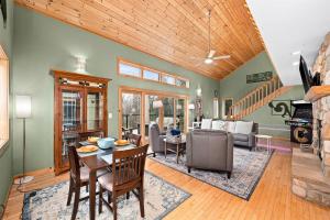 a living room with a table and chairs and a fireplace at You Betcha - Charming 3BR Arcade & Near Lutsen & Grand Marais in Grand Marais