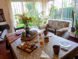 a table with a basket of food on it at Los Pinos B&B in Cosquín
