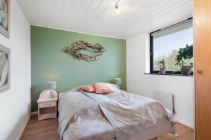 a bedroom with a bed and a window at LF11102-Struer-Snerlevej-2 in Struer
