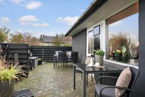 a patio with a table and chairs on a balcony at LF11102-Struer-Snerlevej-2 in Struer +10 photos