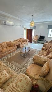 a large living room with couches and a table at إستراحة البستان in Ash Shuwaybiţ