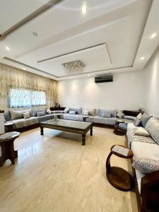 a large living room with couches and a table at 5-star luxury villa with private pool in Marrakech