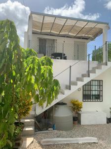 a white house with stairs and plants at CASA JARDIN in Cancún