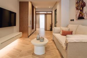 a living room with a couch and a table at Nuvélia, A Minimalist Luxury Story in Zakynthos Town