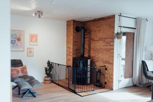 a living room with a brick wall and a fireplace at Kindvriendelijk vakantiehuis in Winterberg met tuin - Modern & rustig gelegen in Winterberg +19 photos