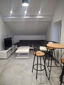 a living room with two tables and a couch at Appartement loft in Mandeure