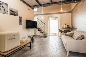 a living room with a couch and a tv at L'Acero Sublime Guesthouse in Feriolo