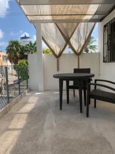 a table and chairs on a patio with a view of the ocean at CASA JARDIN in Cancún