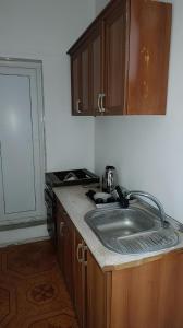 a kitchen with a sink and a counter top at Double Gates Apartment in Baku