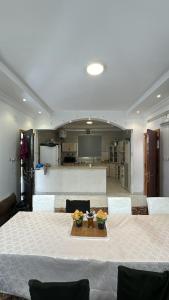 a dining room with a table with flowers on it at إستراحة البستان in Ash Shuwaybiţ