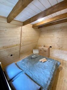 a room with a bed in a wooden room at Diamond chalet A-frame in Ogrody