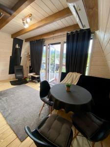 a living room with a black table and chairs at Diamond chalet A-frame in Ogrody +37 photos