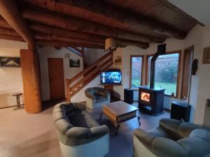 a living room with two couches and a fireplace at Casa Sueño in San Martín de los Andes