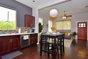 a kitchen with a table and some chairs in it at Private Hot Tub - Walk to Pearl - Pet Friendly 3BR in San Antonio