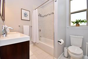 a bathroom with a sink and a toilet and a shower at Private Hot Tub - Walk to Pearl - Pet Friendly 3BR in San Antonio +18 photos
