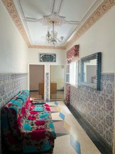 a room with a long row of chairs on a wall at Hébergement authentique in Essaouira