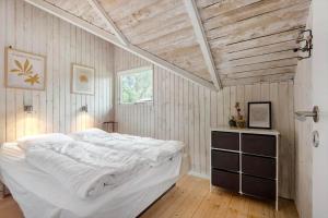 a bedroom with a white bed and a wooden ceiling at BV287-Blavand-Soren-Lassens-Vaenge-11 in Blåvand