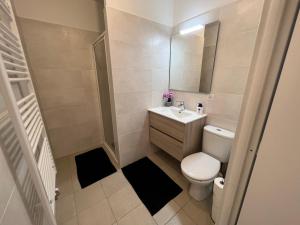 a small bathroom with a toilet and a sink at Spacious apartment in Ivry-sur-Seine