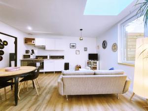 a living room with a couch and a table at Polka - RDC - Centre ville - Terrasse in Auch