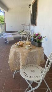 a table with chairs and a table with food on it at Villa Crisett in Civitella San Paolo
