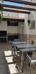 a dining table and chairs on a patio at Casa Bonaire in Chella