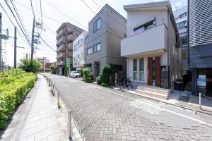 a cobblestone street in a city with buildings at Matsubara Station 2 minutes Shinjuku, Shibuya 15 minutes Pure Japanese style house where you can feel the seasons Maximum 6 people rent a house Quiet house in Tokyo