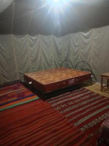 a bed sitting on the floor in a room at Camp azawan hananich 