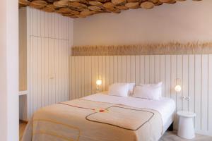 a bedroom with a large white bed with two lamps at Hotel M Soleil - Montpellier Centre Saint Roch in Montpellier