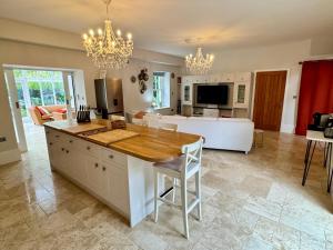 a kitchen with a table and a living room at Stunning and luxurious Manor House holiday home in Broadmayne