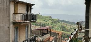 a view of an alley with buildings and a hill at Casa Relax - Relax Holiday in Valledolmo