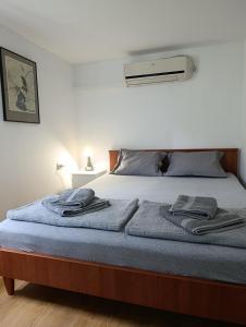 a bed with two towels sitting on top of it at Vikendica Blagojević Čačak in Čačak +37 photos