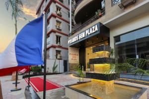 a hotel with a flag in front of a building at Pyramids Gem Plaza Hotel in Cairo