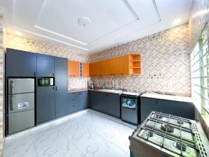 a kitchen with blue cabinets and a stove in it at Résidences Sica in Cotonou +6 photos
