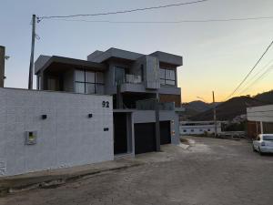 a building with a parking lot in front of it at Loft Tavares in Caparaó Velho