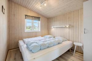 a bedroom with a bed in a room with a window at FY139-Middelfart-Altairvej-20 in Middelfart