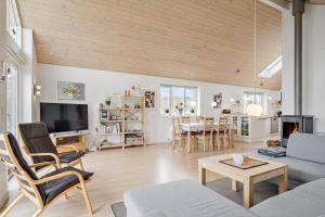 a living room with a couch and a table at 138-Ringkobing-Sondervig-Klitvej-3 in Ringkøbing