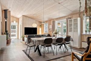 a living room with a dining room table and chairs at 1093-ringkobing-Fyrrealle-3 in Ringkøbing