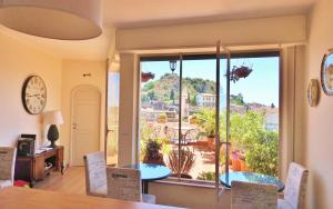 a dining room with a table and chairs and a large window at Cielo di Taormina in Taormina