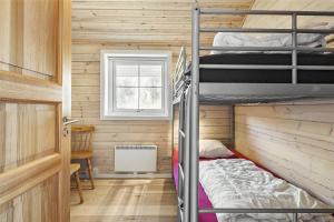 a room with two bunk beds and a window at 128-Ringkobing-Troldedalen-18 in Nørby