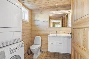 a small bathroom with a toilet and a sink at 128-Ringkobing-Troldedalen-18 in Nørby +20 photos