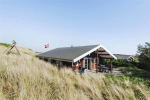 a house sitting on top of a hill at 128-Ringkobing-Troldedalen-18 in Nørby