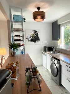 eine Küche mit einer Holzarbeitsplatte und einem Geschirrspüler in der Unterkunft Cosy 2P - Parking - Tram - Marché de Noël à 20min in Ostwald