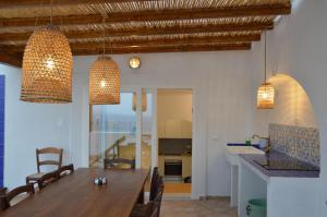 a kitchen and dining room with a table and chairs at Terrazza Aragonese in Ischia Town