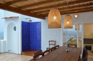 a dining room with a wooden table and chairs at Terrazza Aragonese in Ischia Town +25 photos